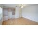 Bright bedroom featuring a ceiling fan and built in shelving units with laminate wood flooring at 8064 Brentwood Rd, Seminole, FL 33777