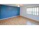 Bedroom boasts laminate flooring, ceiling fan, and natural light at 8064 Brentwood Rd, Seminole, FL 33777