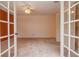 Bedroom with French doors, ceiling fan, and a closet providing storage solutions at 8064 Brentwood Rd, Seminole, FL 33777