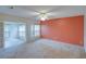 Bedroom with carpet, ceiling fan, and an attached sunroom at 8064 Brentwood Rd, Seminole, FL 33777