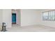 Bright bedroom features neutral carpet, simple window with blinds, and light walls at 8064 Brentwood Rd, Seminole, FL 33777
