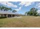 Stone building with American flag and benches in a well-maintained outdoor space at 8064 Brentwood Rd, Seminole, FL 33777