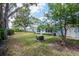 Beautiful home exterior with lovely landscaping, mature trees and blue sky at 8064 Brentwood Rd, Seminole, FL 33777