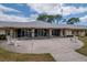 Exterior view of the Clubhouse featuring stone columns and seating area at 8064 Brentwood Rd, Seminole, FL 33777