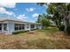 Charming blue home featuring well-manicured lawn and lush landscaping at 8064 Brentwood Rd, Seminole, FL 33777