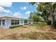 Charming blue home featuring well-manicured lawn and lush landscaping at 8064 Brentwood Rd, Seminole, FL 33777