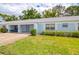 Single-story home with a well-manicured lawn, blue paint, and a one-car garage at 8064 Brentwood Rd, Seminole, FL 33777