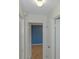 Hallway view leading to a bedroom with hardwood floors and painted blue wall at 8064 Brentwood Rd, Seminole, FL 33777