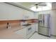 The kitchen is equip with modern stainless steel refrigerator and white appliances at 8064 Brentwood Rd, Seminole, FL 33777