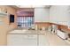 Charming kitchen with white cabinetry, neutral countertops and modern appliances at 8064 Brentwood Rd, Seminole, FL 33777