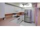 Bright kitchen features white cabinets, neutral countertops, and stainless steel refrigerator at 8064 Brentwood Rd, Seminole, FL 33777