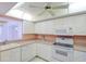 Well maintained kitchen with modern white appliances and great natural lighting at 8064 Brentwood Rd, Seminole, FL 33777