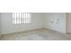 Bright room showcasing neutral carpet and a window with blinds, with a white door and trim at 8064 Brentwood Rd, Seminole, FL 33777