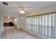 Well lit living room featuring tile floors, white walls, and large window with window blinds at 8064 Brentwood Rd, Seminole, FL 33777