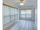 Inviting living room space featuring tile floors, white walls, and plenty of sunlight from the windows at 8064 Brentwood Rd, Seminole, FL 33777