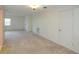 Well-lit living room showcasing neutral carpet and a window with blinds, offering comfortable and functional living space at 8064 Brentwood Rd, Seminole, FL 33777