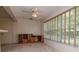 Living room features wooden built in desk and display cabinet as well as lots of light from large windows at 8064 Brentwood Rd, Seminole, FL 33777