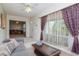 Stylish living room with a gray sofa, tiled floor, and natural light at 8064 Brentwood Rd, Seminole, FL 33777