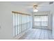 Cozy living room area with tile flooring and large window with blinds, offering natural light at 8064 Brentwood Rd, Seminole, FL 33777