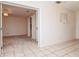 Open-concept living space features neutral tiled flooring and access to another area at 8064 Brentwood Rd, Seminole, FL 33777