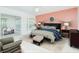 Comfortable bedroom with neutral carpet, en suite office and accent wall at 8064 Brentwood Rd, Seminole, FL 33777