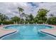 Lovely community pool with wading area, chairs, and lush landscaping on a bright, sunny day for residents and guests at 8064 Brentwood Rd, Seminole, FL 33777