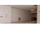 Bright living room featuring neutral carpet, fresh paint and a white front door at 8064 Brentwood Rd, Seminole, FL 33777