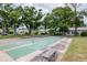 Shuffleboard courts lined up in a row between lush landscaping and trees for hours of outdoor activity at 8064 Brentwood Rd, Seminole, FL 33777