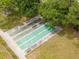 Aerial view of shuffleboard courts next to manicured lawn and mature trees at 8064 Brentwood Rd, Seminole, FL 33777