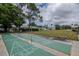 Outdoor shuffleboard courts located near the clubhouse surrounded by shady trees and green lawns at 8064 Brentwood Rd, Seminole, FL 33777