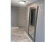 Hallway features neutral decor, a large mirror, and ceramic tile flooring at 880 Mandalay Ave # S302, Clearwater Beach, FL 33767