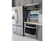 The kitchen has stainless steel appliances including refrigerator, oven, and microwave at 880 Mandalay Ave # S302, Clearwater Beach, FL 33767