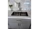 The kitchen sink is a double basin style featuring neutral cabinets and matching marble countertops at 880 Mandalay Ave # S302, Clearwater Beach, FL 33767