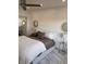 Inviting bedroom featuring plush bedding, stylish mirrors, and ample natural light at 880 Mandalay Ave # S302, Clearwater Beach, FL 33767
