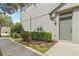 Exterior entrance to a well-maintained townhome with green door at 8848 Moonlit Meadows Loop, Riverview, FL 33578