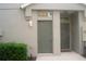 Front entrance featuring two numbered doors and manicured landscaping at 8848 Moonlit Meadows Loop, Riverview, FL 33578