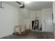 Empty two car garage with a water heater at 8848 Moonlit Meadows Loop, Riverview, FL 33578