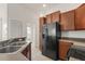 Kitchen with dark appliances and view to open floor plan at 8848 Moonlit Meadows Loop, Riverview, FL 33578