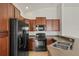 Kitchen with dark appliances, cabinets, and stainless steel sink at 8848 Moonlit Meadows Loop, Riverview, FL 33578