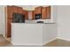 Kitchen featuring wood cabinets and modern appliances at 8848 Moonlit Meadows Loop, Riverview, FL 33578