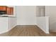 Bright living room with wood floors open to the kitchen at 8848 Moonlit Meadows Loop, Riverview, FL 33578