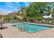 Community pool with lounge chairs, landscaping, and a lifeguard stand at 8848 Moonlit Meadows Loop, Riverview, FL 33578