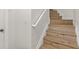 Wooden staircase with white handrail in a modern townhome at 8848 Moonlit Meadows Loop, Riverview, FL 33578