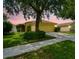 Charming single-Gathering home featuring lush landscaping, a two-car garage, and a well-maintained lawn at 9551 Maxson Dr, Land O Lakes, FL 34638