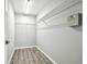 Large walk-in closet with ample shelving and space for storage at 9551 Maxson Dr, Land O Lakes, FL 34638