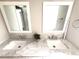 Bathroom vanity featuring dual sinks, framed mirrors, and a marble countertop at 10208 Oak Hill Dr, Port Richey, FL 34668