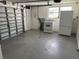 Unfinished garage featuring concrete floors, appliances, and garage door at 10208 Oak Hill Dr, Port Richey, FL 34668