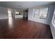 Bright living room with wood-look floors and a large window at 10208 Oak Hill Dr, Port Richey, FL 34668