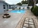 Beautiful backyard pool area with brick pavers and white fence at 10208 Oak Hill Dr, Port Richey, FL 34668