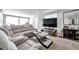 Spacious living room featuring a plush sectional sofa, a large TV, and modern decor elements throughout at 10381 108Th Ave, Largo, FL 33773